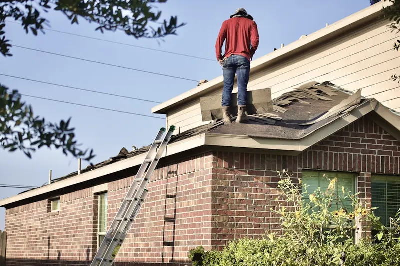 Professional roofer working on a residential roof in Rivercliff